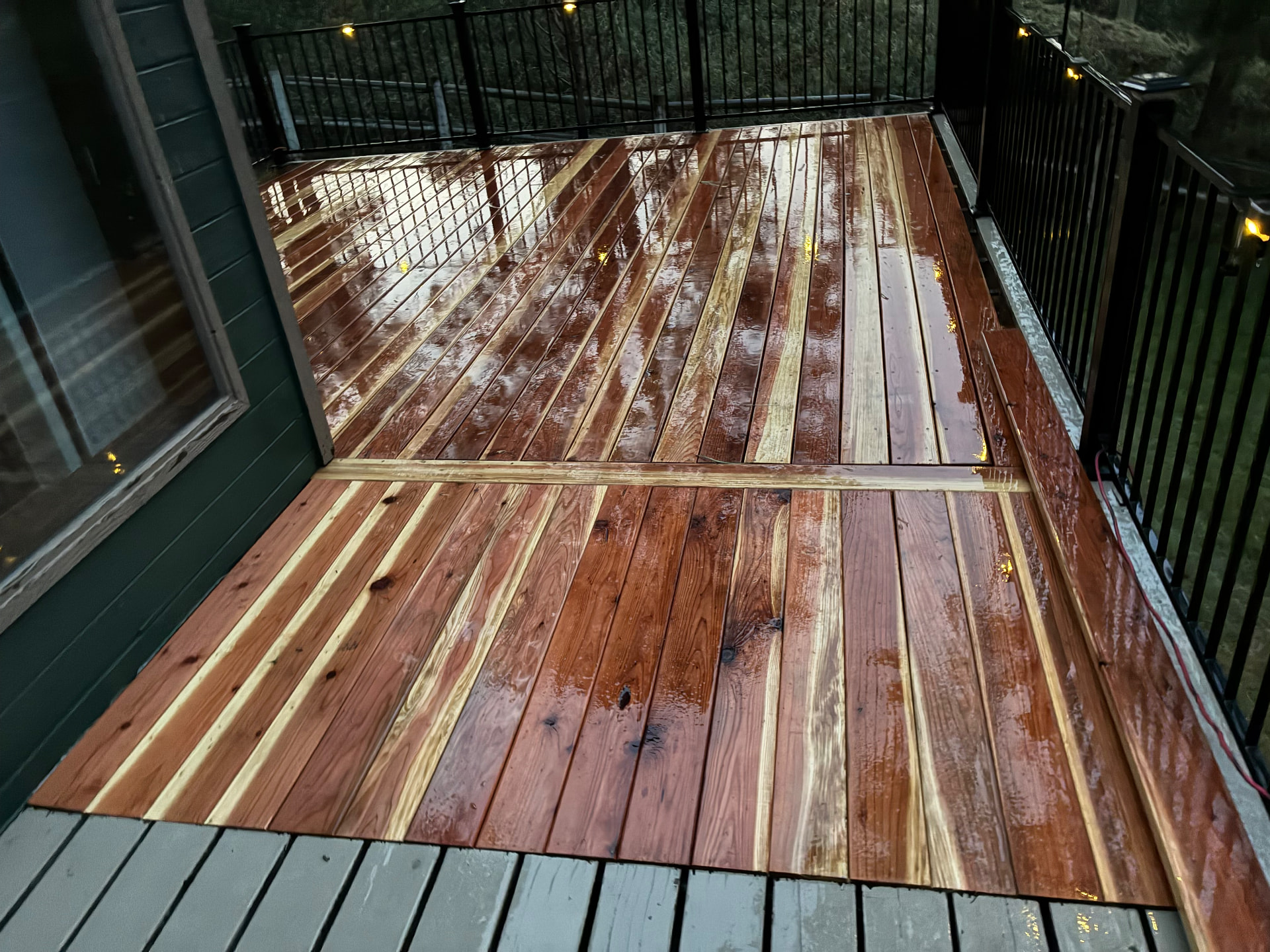 Wide view of the stained deck overlooking a wooded hillside