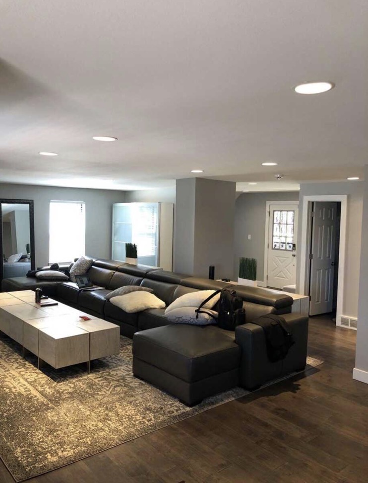 Open living room with new recessed lighting and hardwood floors